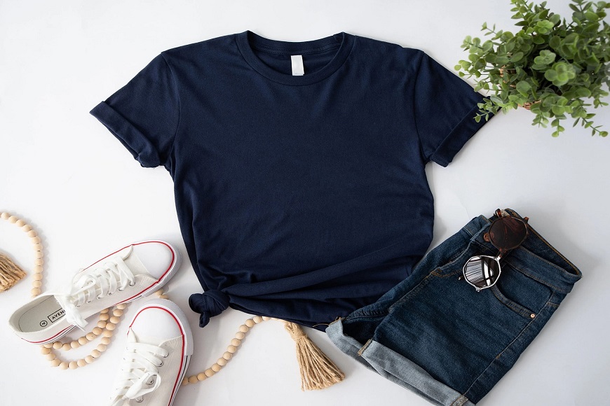 A navy t - shirt, shorts and sneakers on a white background.