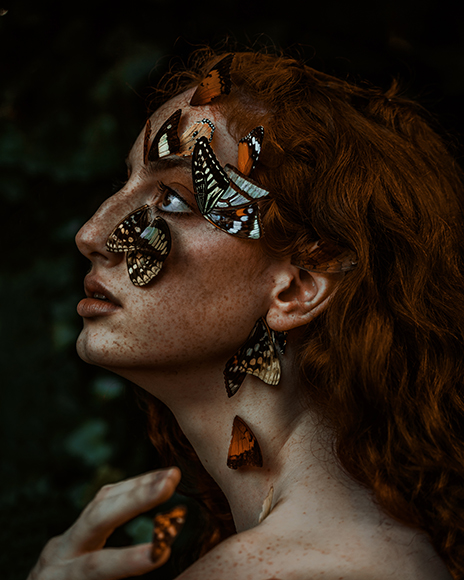 A woman with butterflies on her face.