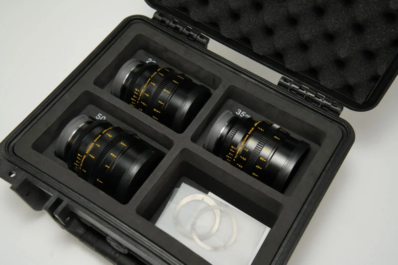 A black case with four lenses in it.