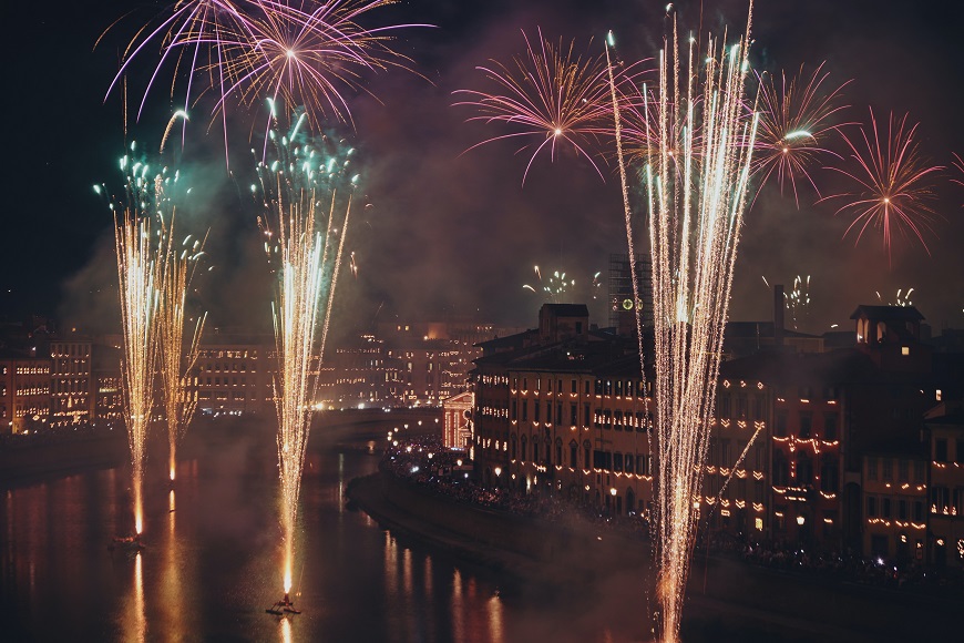 Fireworks over a river in florence, italy.