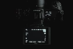 A camera with a screen on it in a dark room.