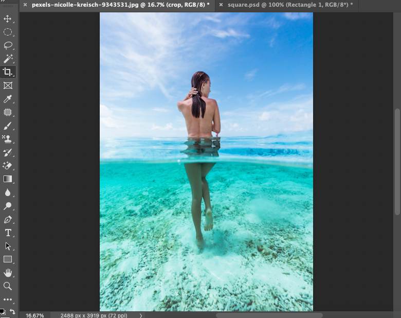 A photo of a woman standing in the water in adobe photoshop.