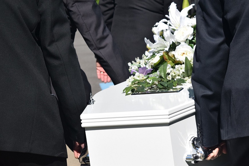 A group of men in suits carrying a casket.