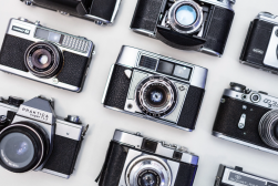A group of vintage cameras on a white background.