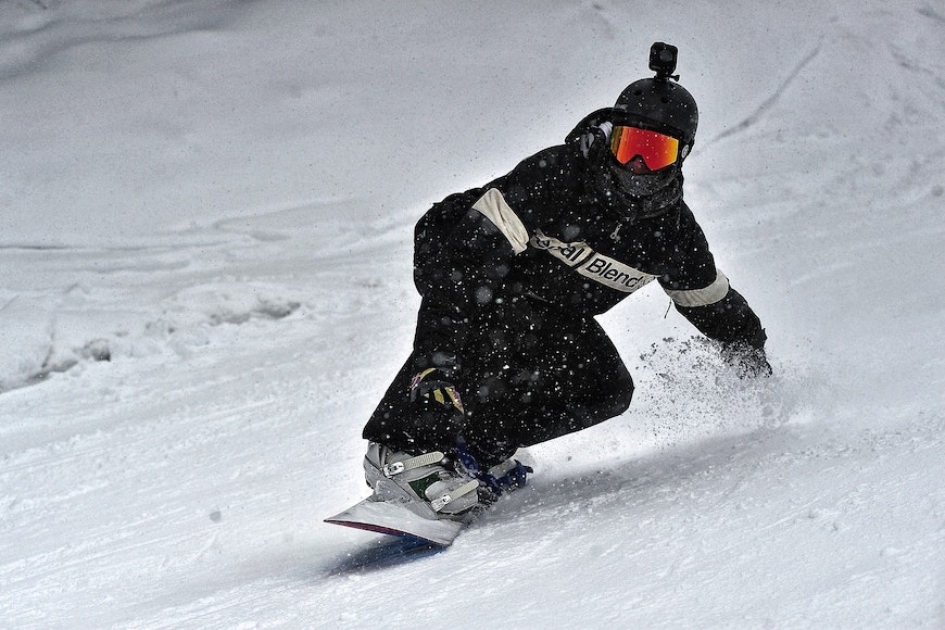 A person riding a snowboard down a hill.