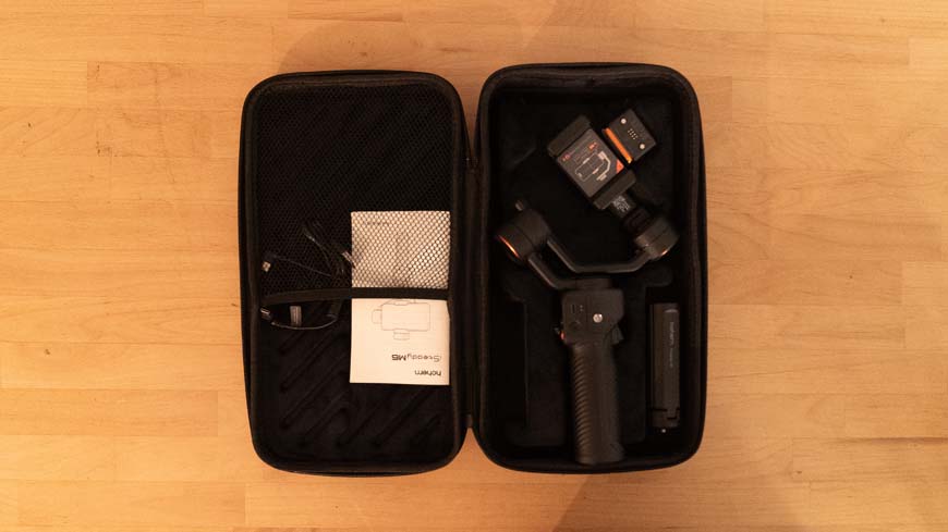 A black case with a tripod and a gimbal in it.