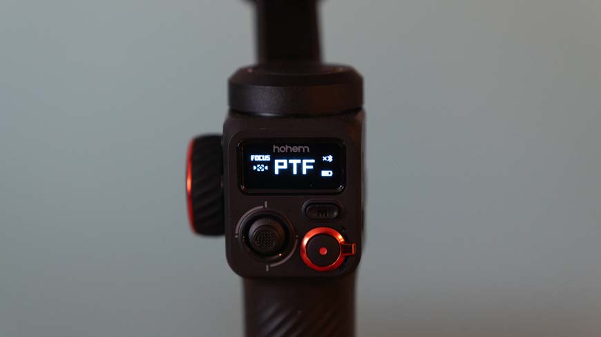 A small electronic gimbal with a menus screen on it.