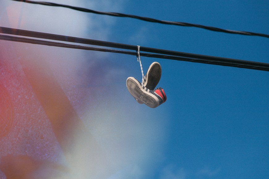 A pair of shoes hanging from a wire.
