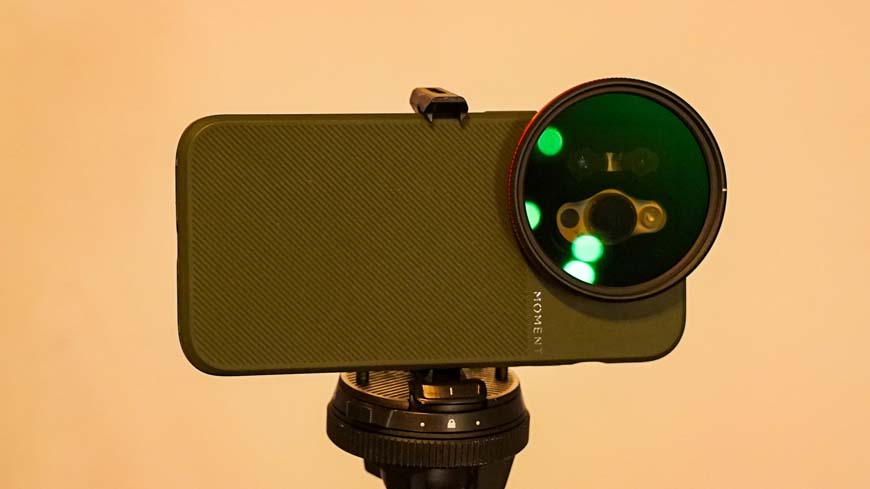 A green phone with a lens attached to it.