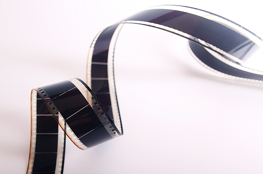 A black and white film strip on a white surface.