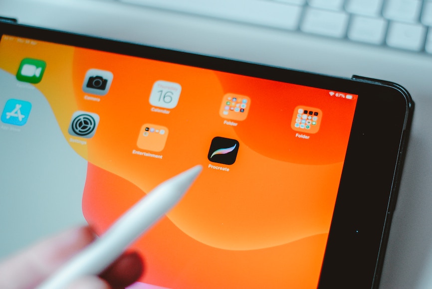 A person is holding a pen on an ipad.