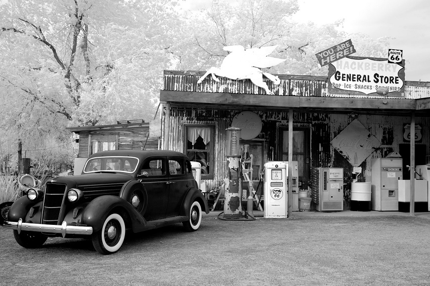 A black and white photograph of a gas station.