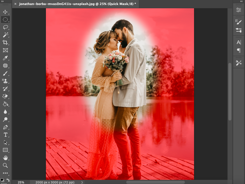 A photo of a couple kissing on a dock in adobe photoshop.