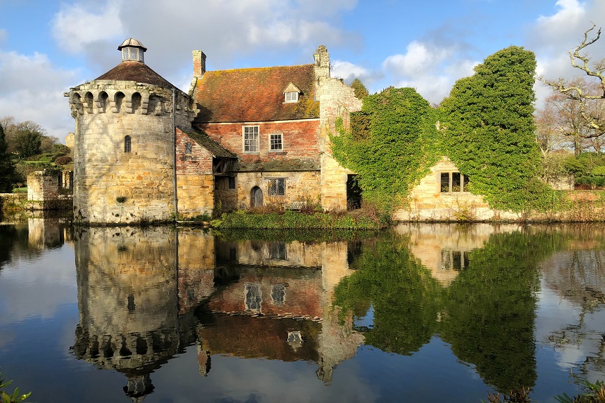 A castle is reflected in a body of water.