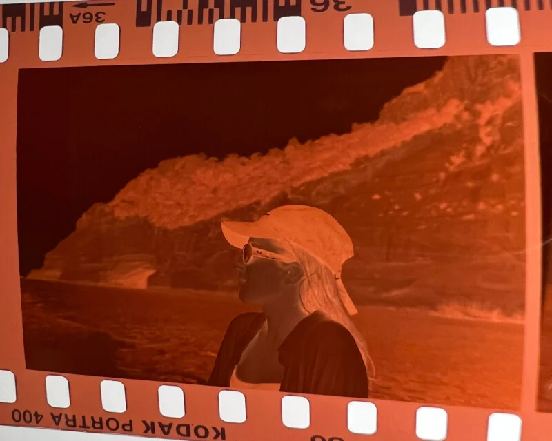 A photo of a woman in a hat on a film strip.