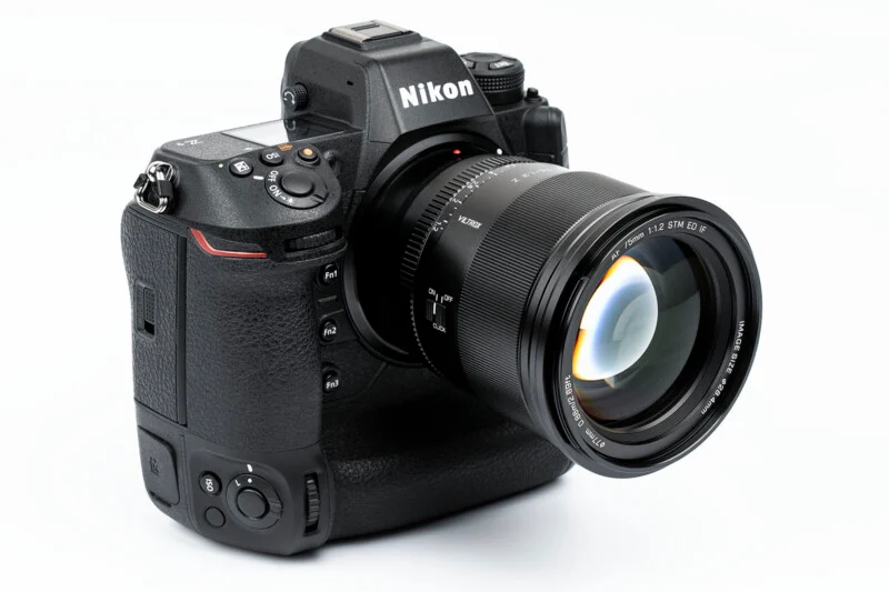 A nikon dslr camera with a lens attached.