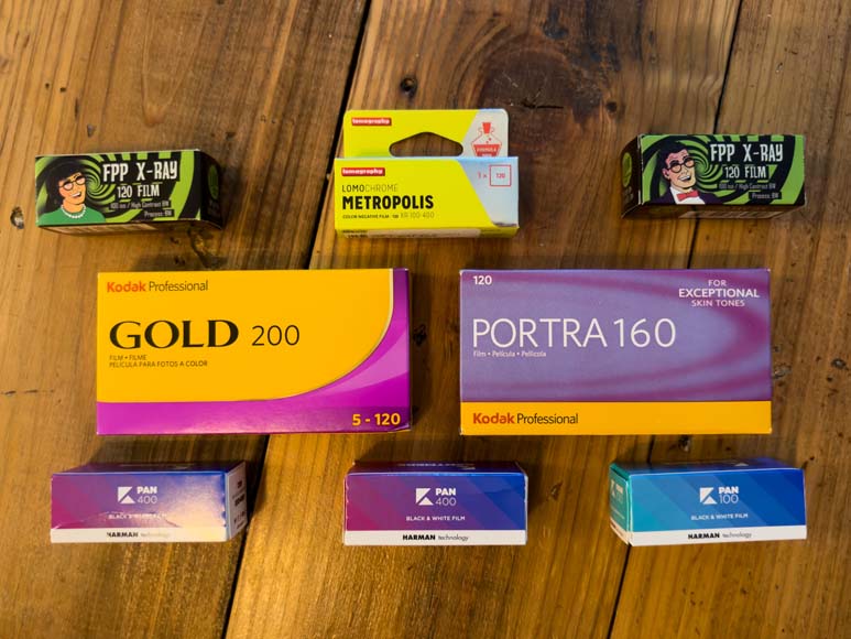 A variety of different types of film on a wooden table.