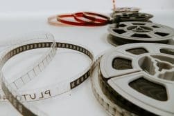 A group of film reels on a white surface.