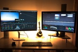 A desk with two monitors showing DaVinci Resolve.