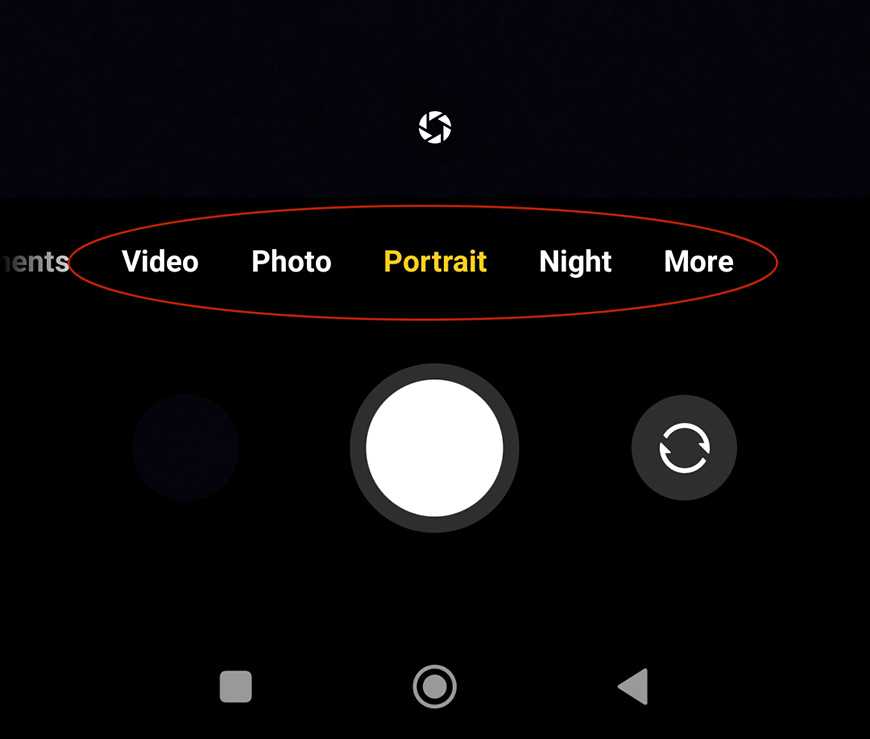 A phone with the video, photo, night, and more buttons highlighted.