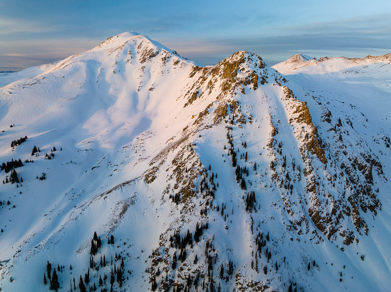 An aerial view of a snow covered mountain.
