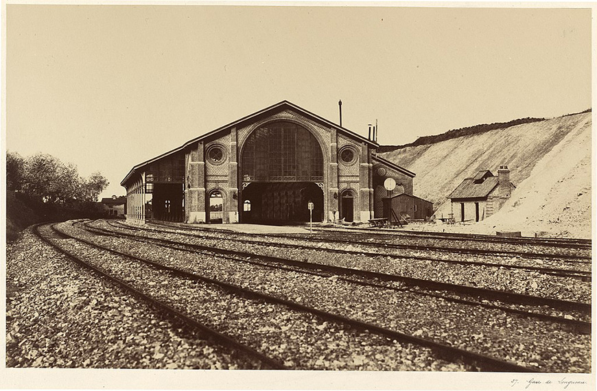 A black and white photo of a train station.