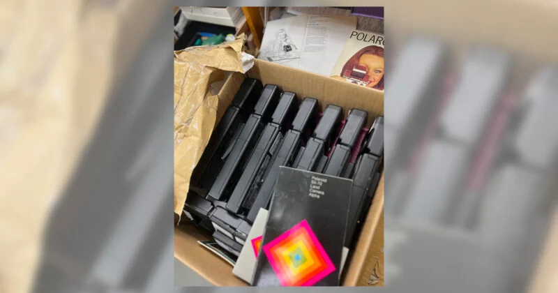 A box with Polaroid 680 cameras in it.