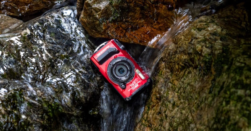An OM TG-7 sitting on a rock in a river.