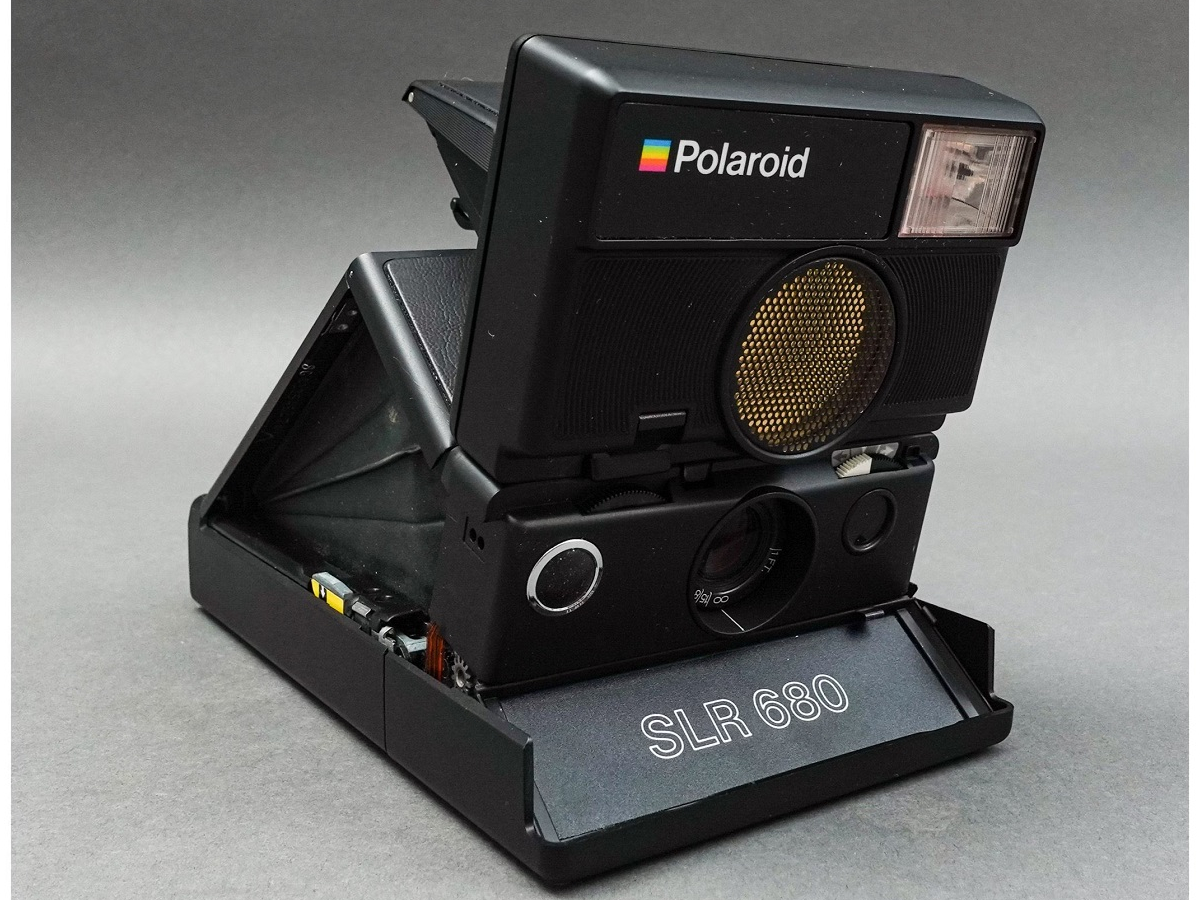 A polaroid 680 camera with a black cover.