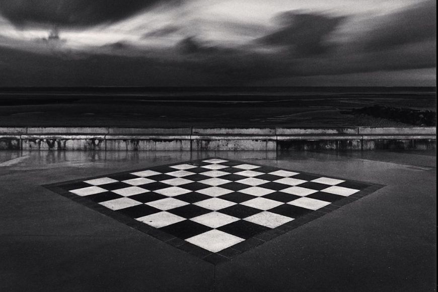 A black and white photograph of a chess board.