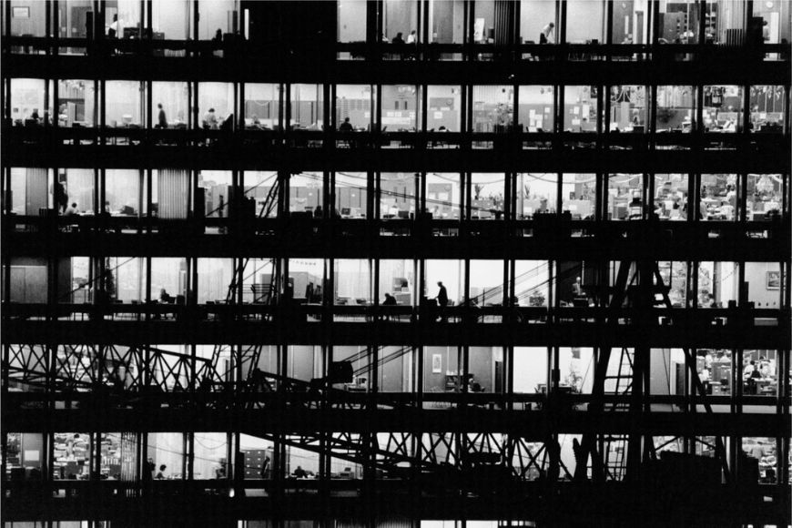 A black and white photo of a building with many windows.