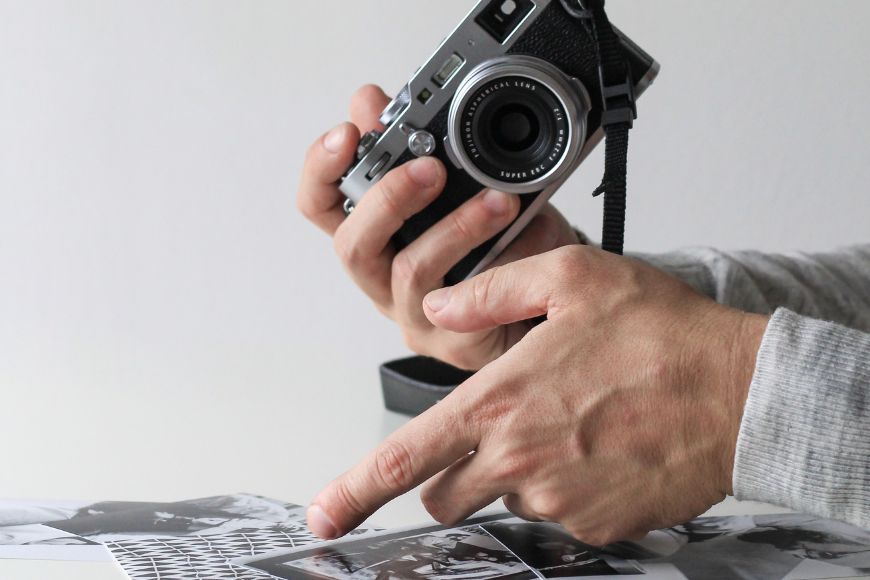A man is holding a camera and taking photos.