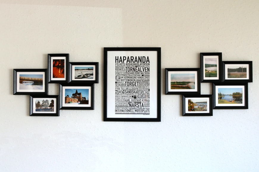 A set of black and white pictures hung on a wall.