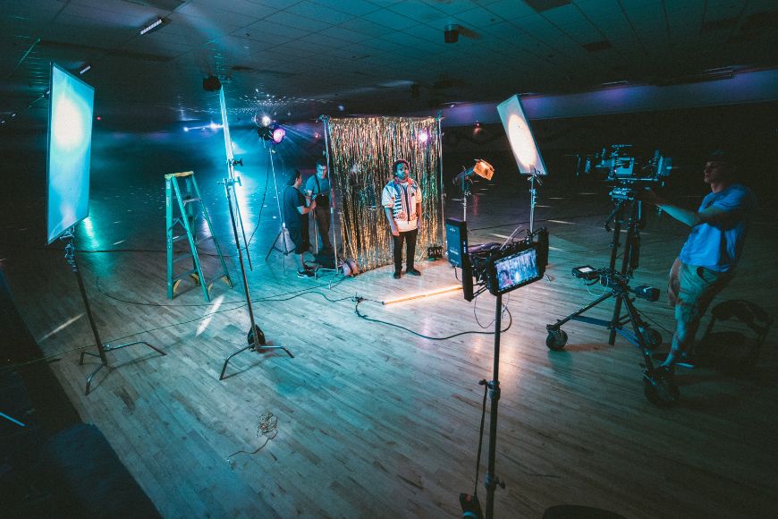 A group of people in a room with lighting equipment.