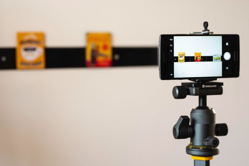 A smartphone on a tripod with a photo on it.
