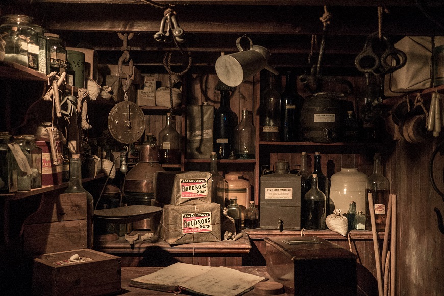 A room full of old items in a wooden cabinet.