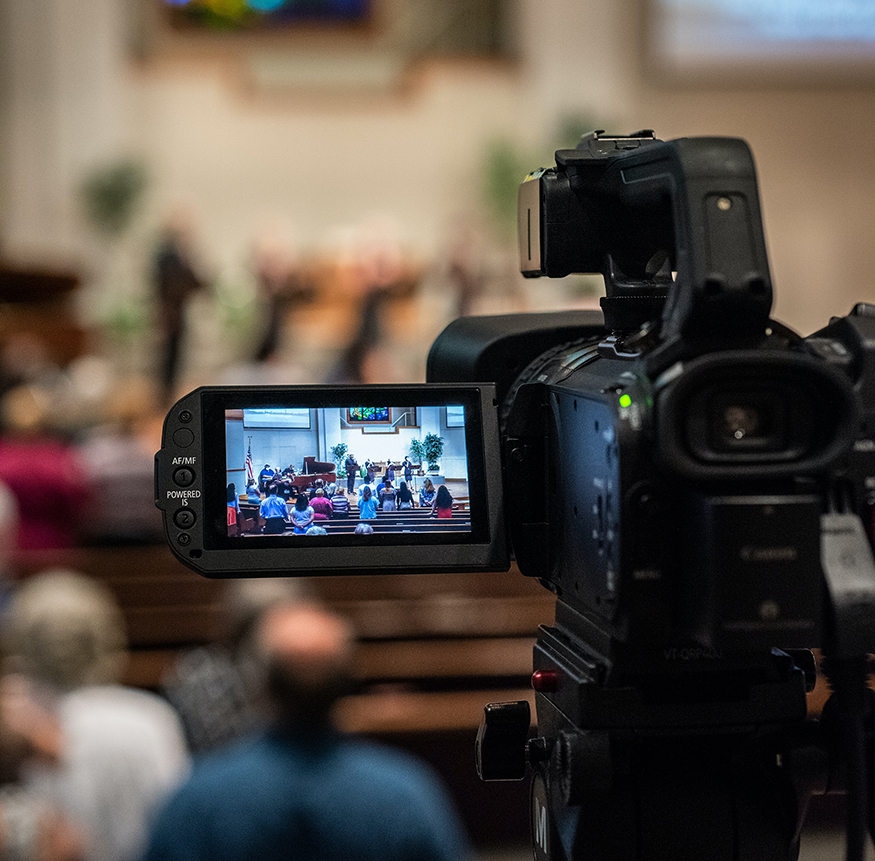 A video camera is being used in a church.