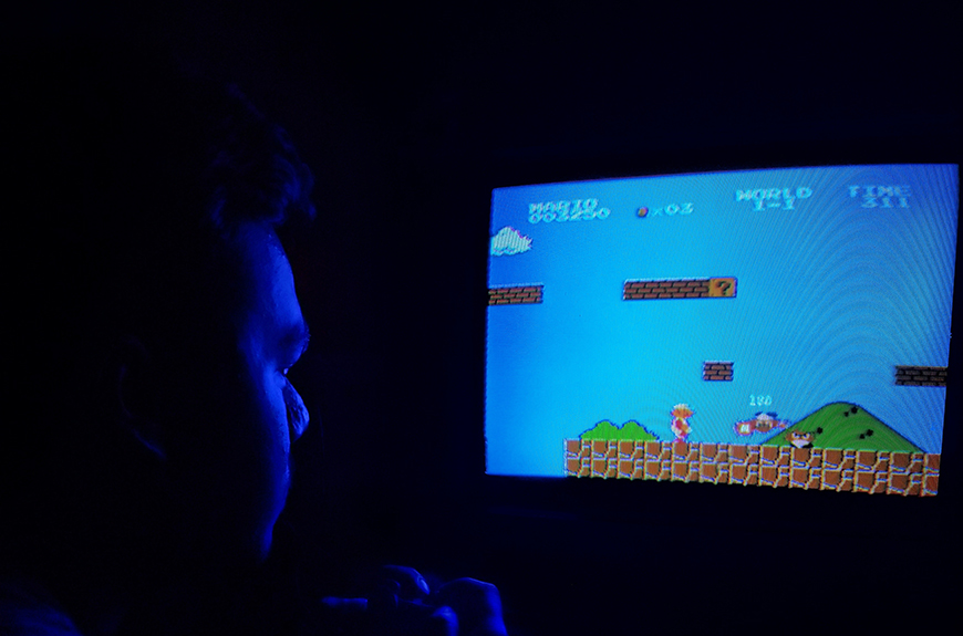 A man playing a video game on a tv.