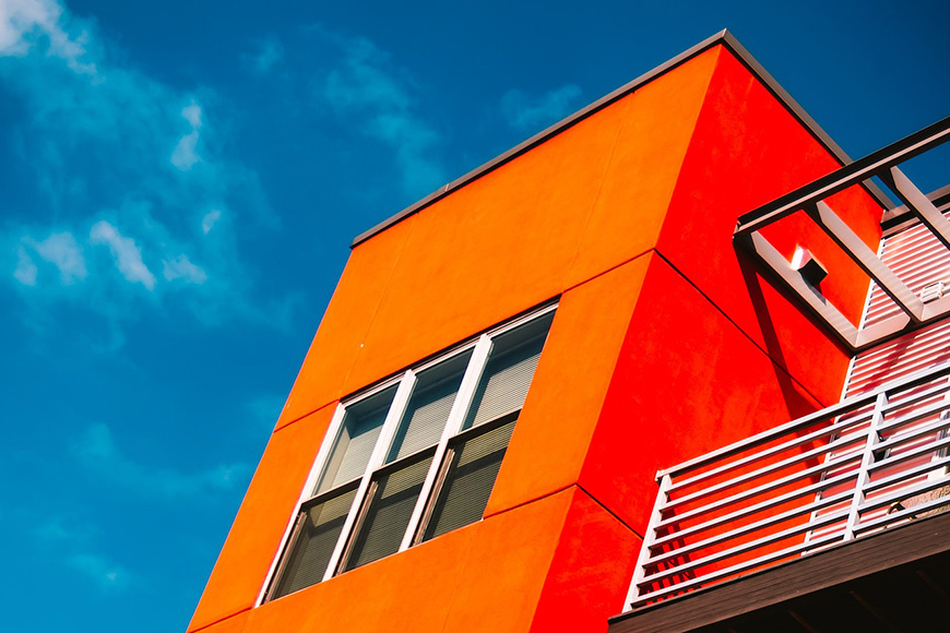 An orange building with a blue sky.
