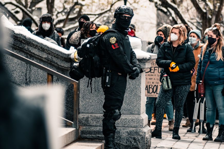A group of people wearing masks and walking down steps.