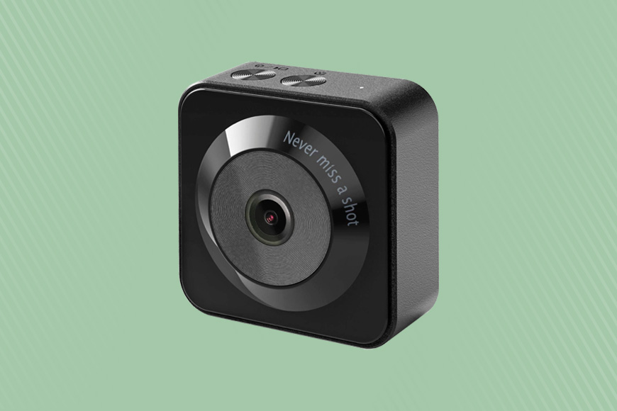 A small black camera on a green background.