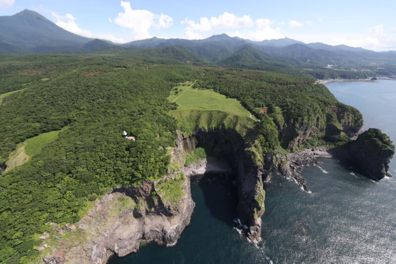 An aerial view of a cliff overlooking the ocean.