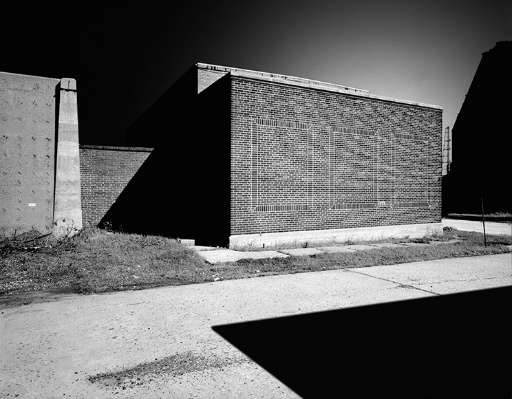 A black and white photo of a brick building.