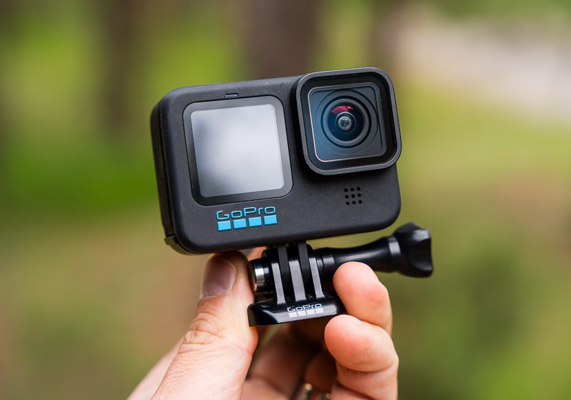 A person holding up a gopro action camera.