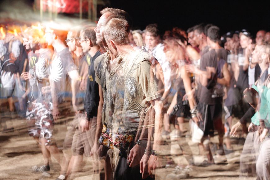A blurry image of a group of people at a festival.