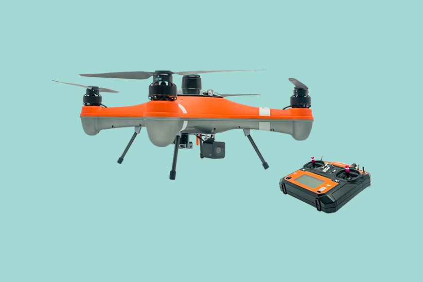 A small orange drone with a remote control attached to it.