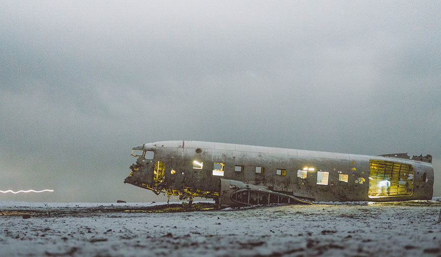 A plane sitting on a snowy field.