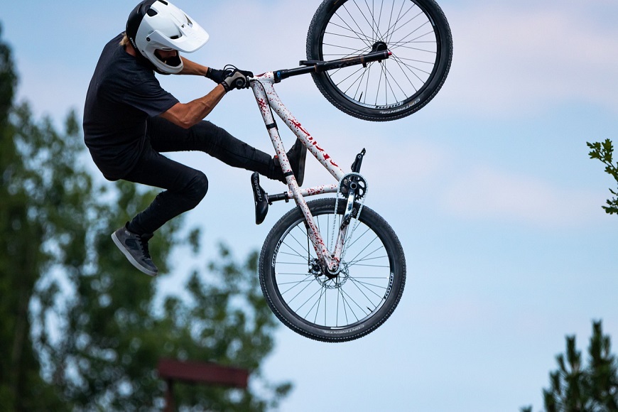 A person doing a trick on a bike in the air.