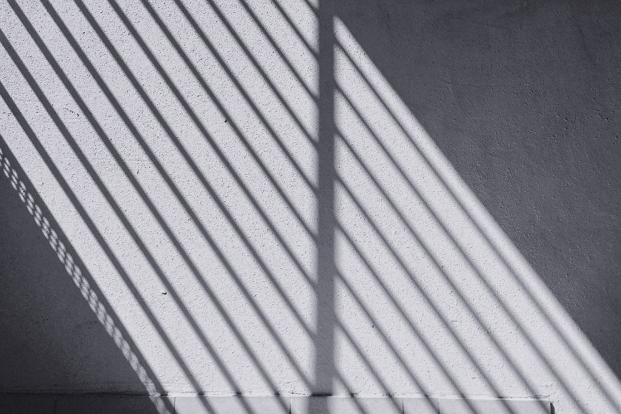 A black and white photo of a shadow on a wall.