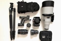 A group of camera equipment laid out on a white surface.